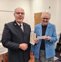 Presentation by President Kath to the Bolton Salvation Army at a Christmas carol event